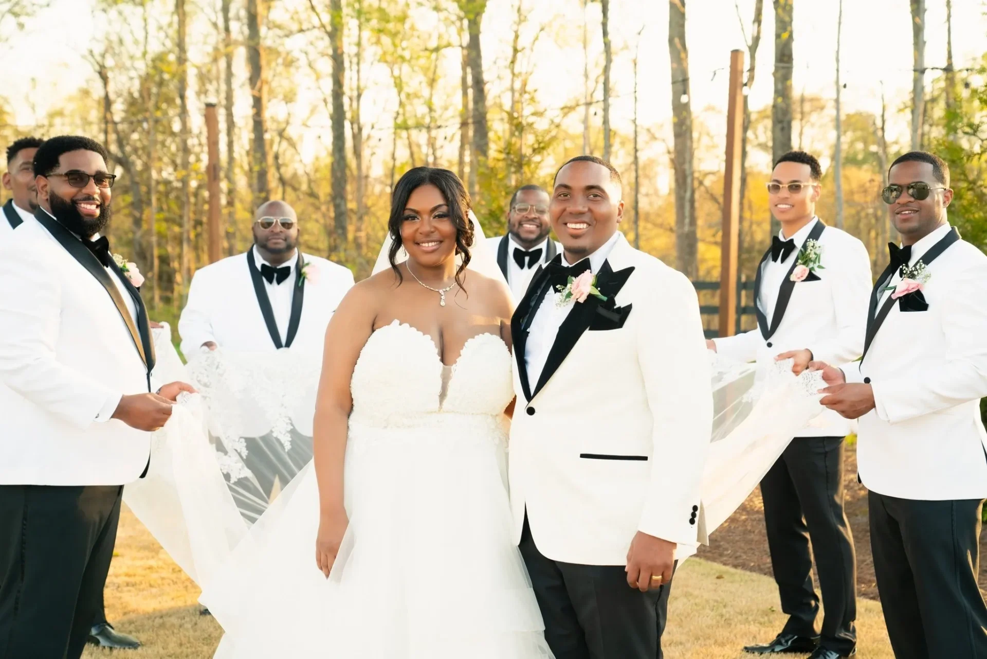 A couple poses for a picture with their wedding party.