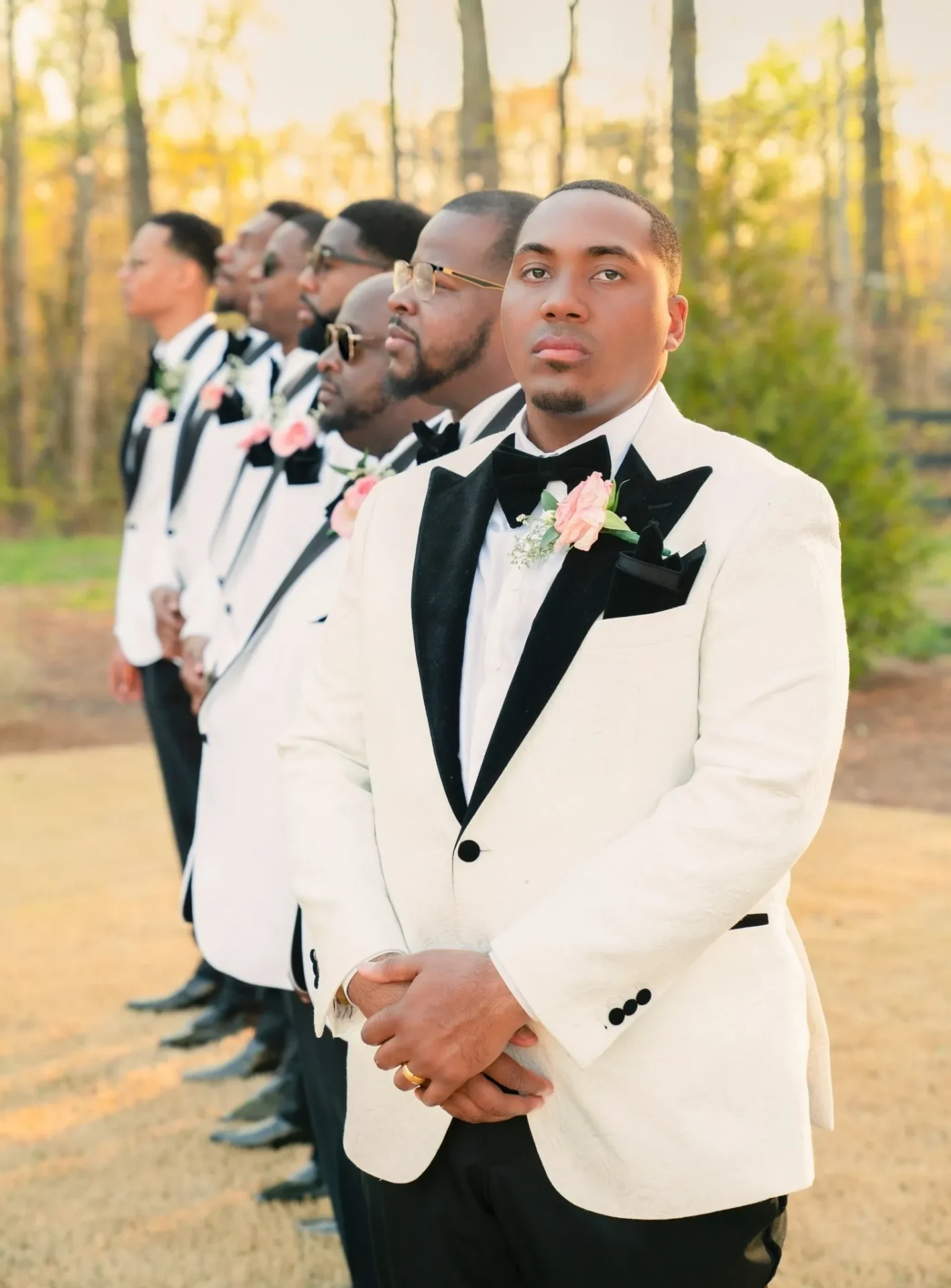 A group of men in tuxedos standing next to each other.