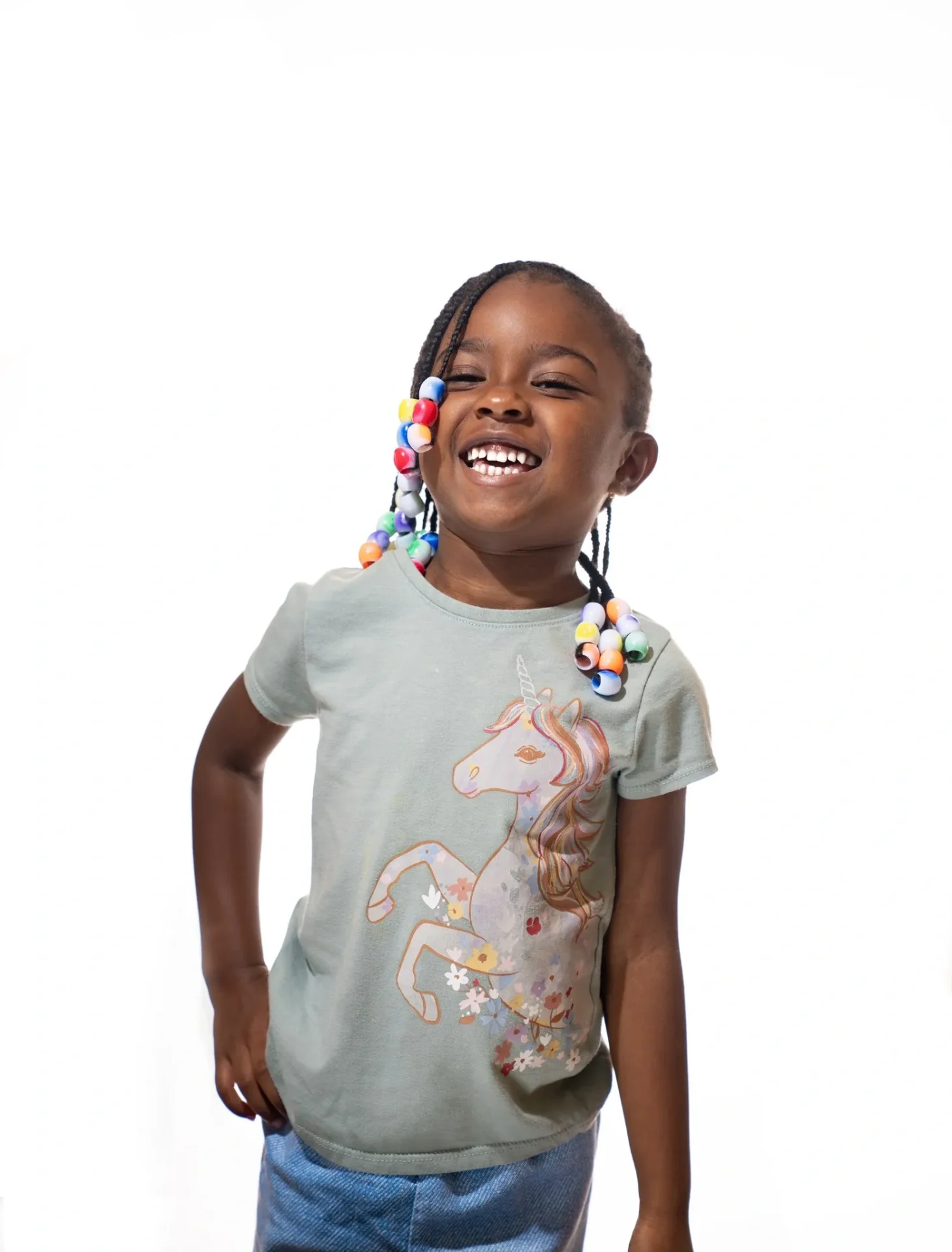 A young girl wearing a t-shirt with a horse on it.