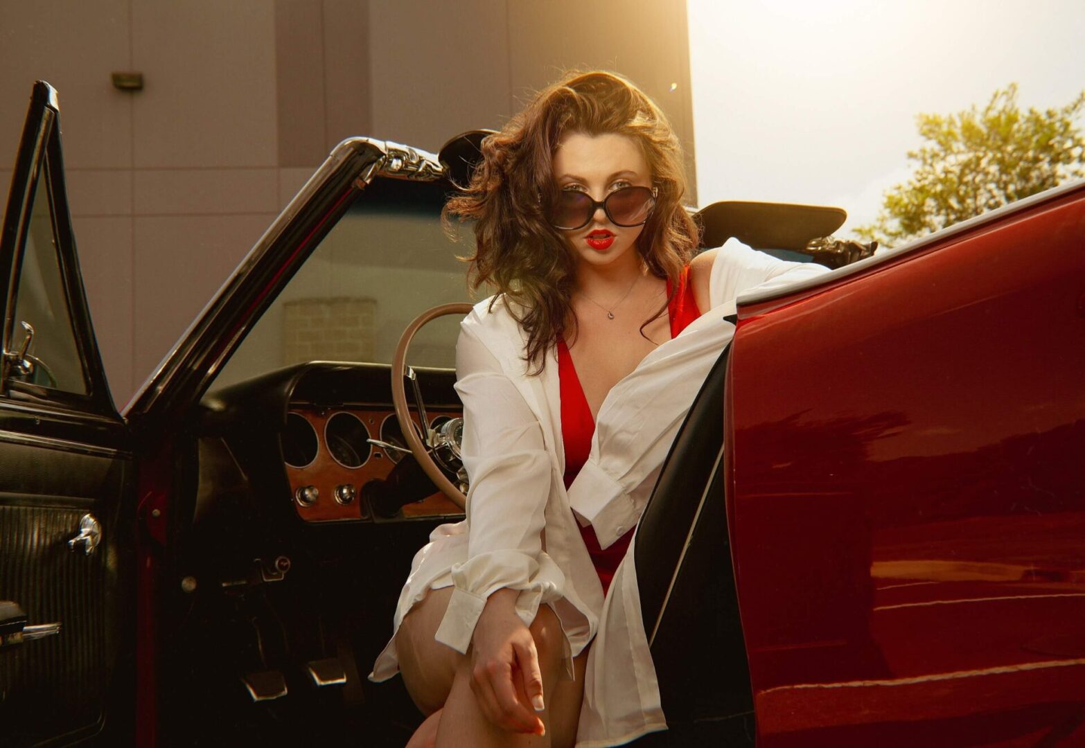 A woman sitting in the driver 's seat of a car.