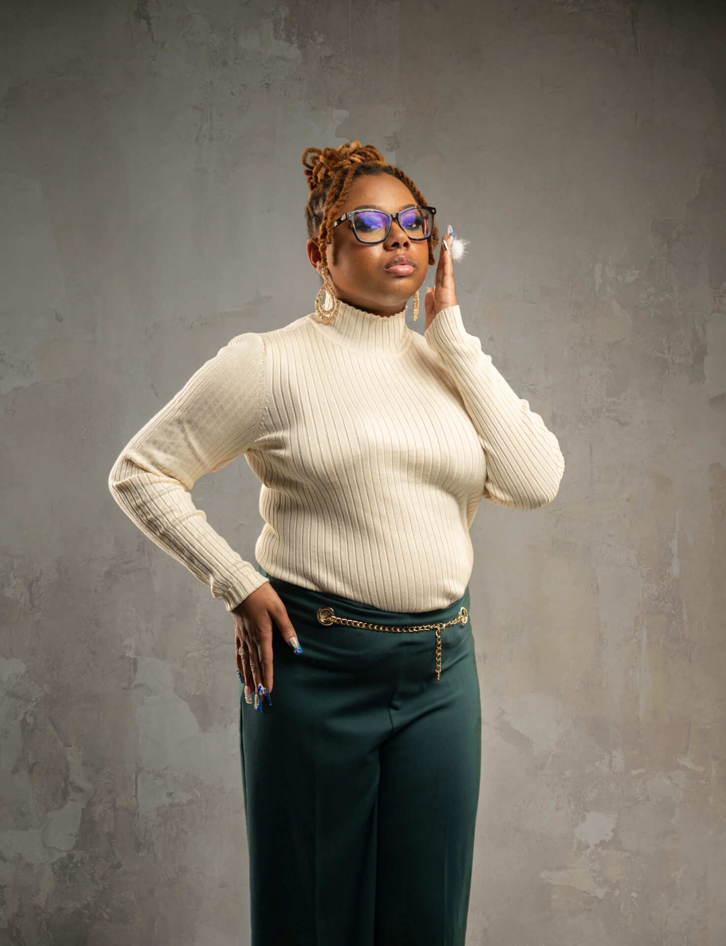 A woman in white sweater holding a phone to her ear.