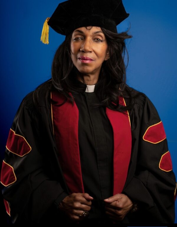 A woman in a graduation cap and gown.